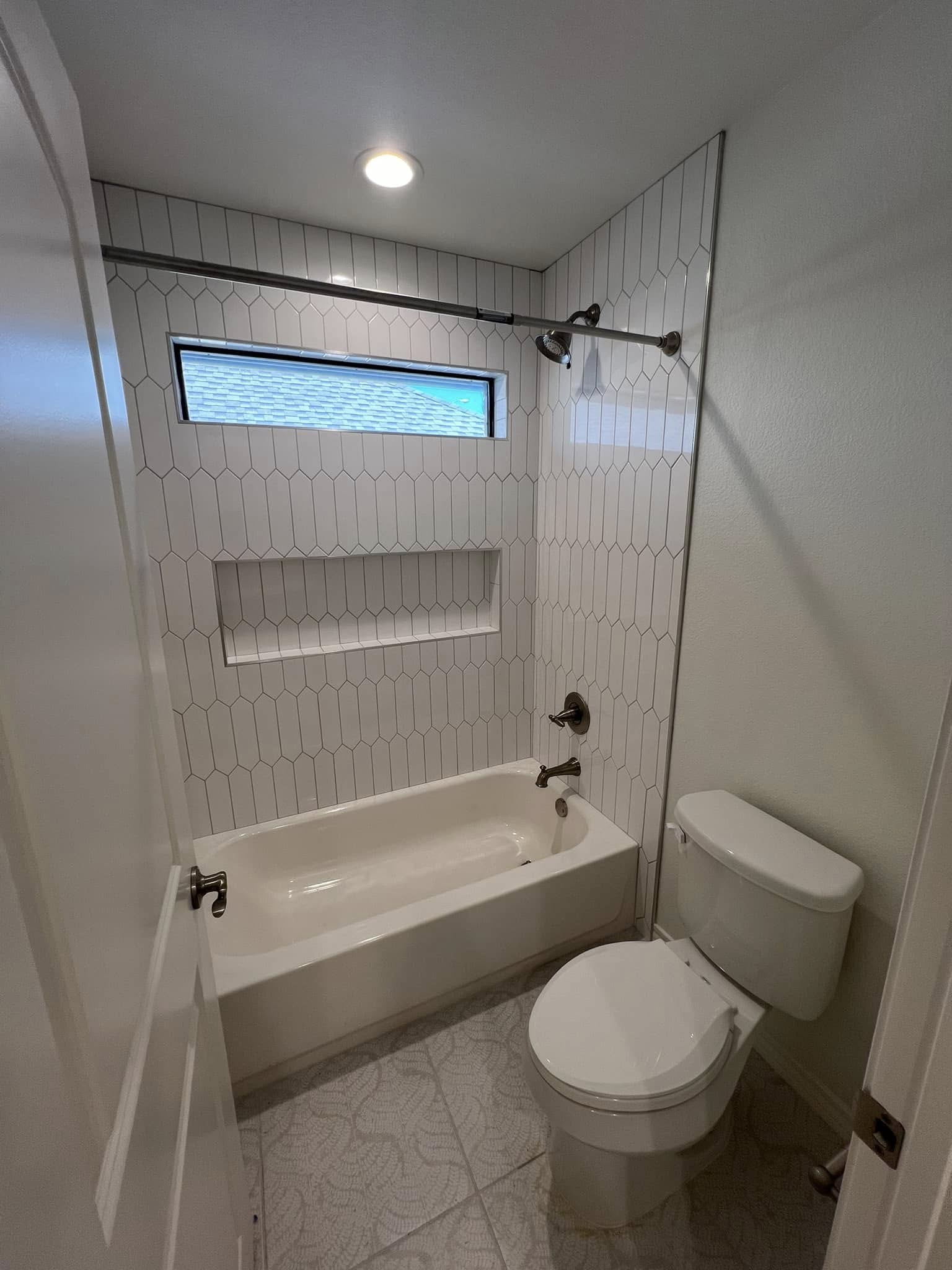 Hall bathroom remodel with custom picket tile and built-in niche in Benbrook