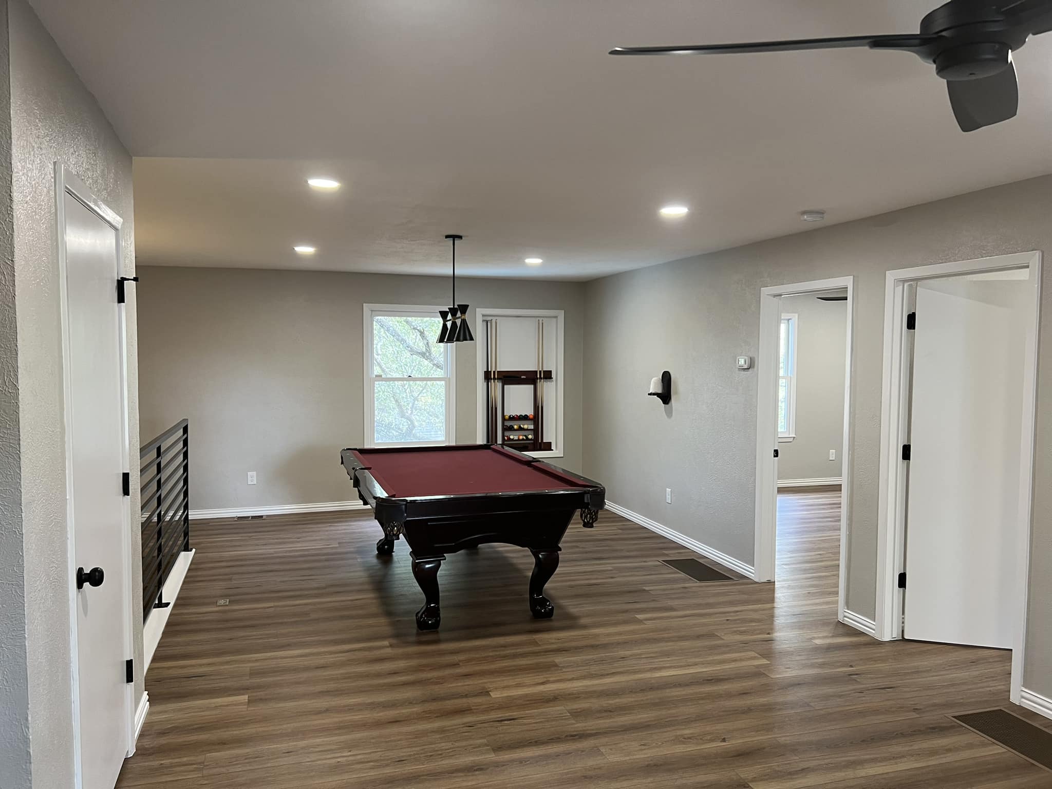Game room remodel with custom built-ins and hardwood flooring near Hulen