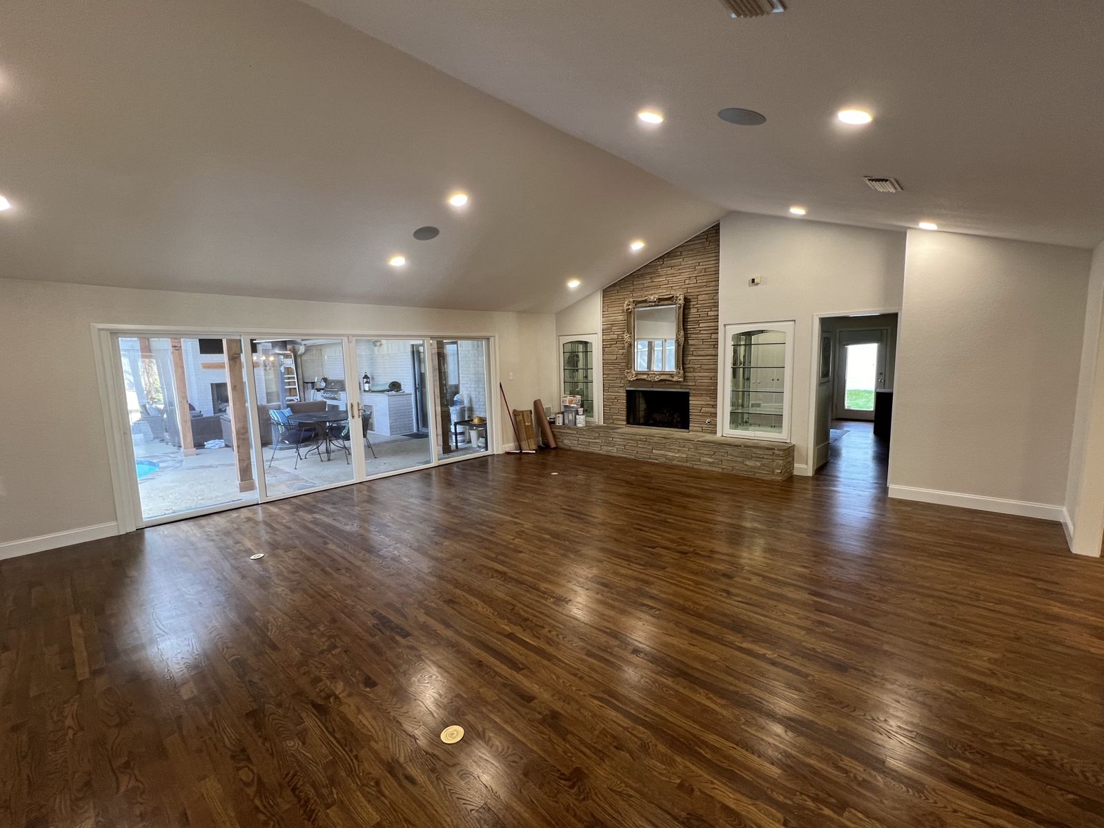 Refinished dark-stained hardwood floors in an open living room