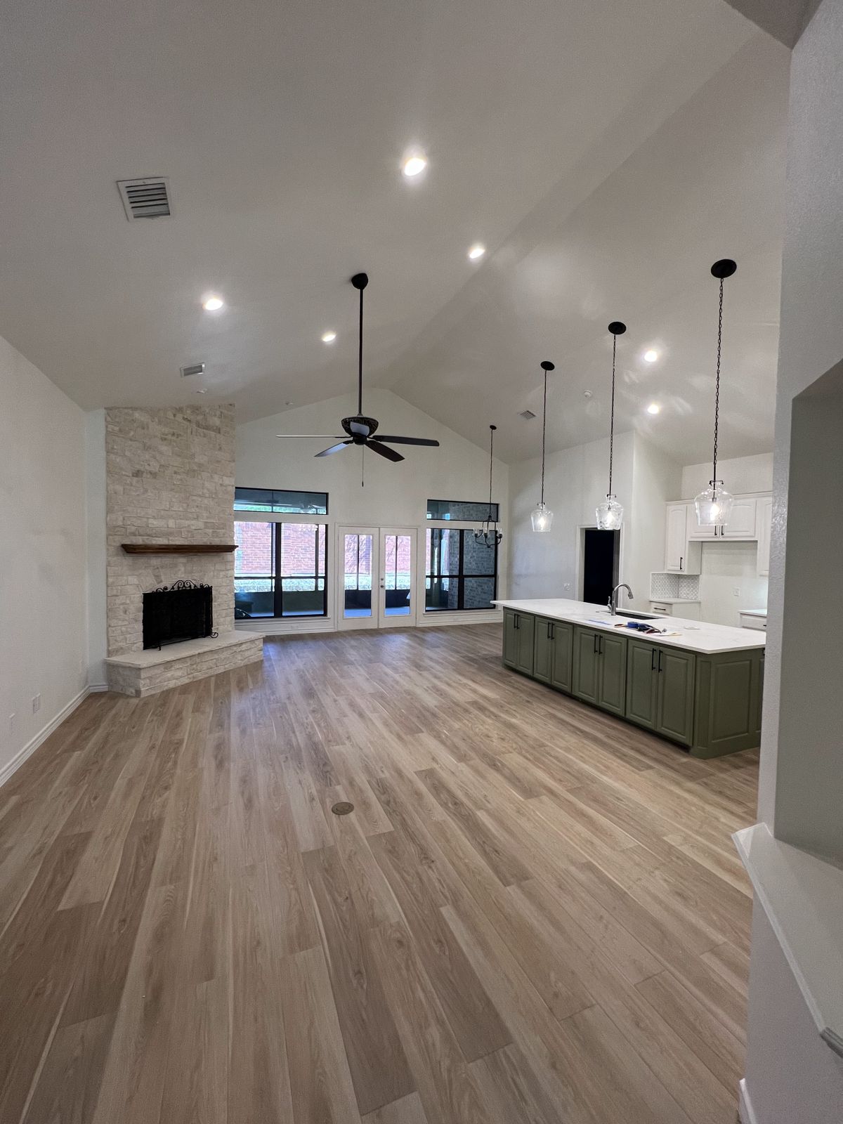 Open-plan living area with new luxury vinyl plank flooring and painted ceilings