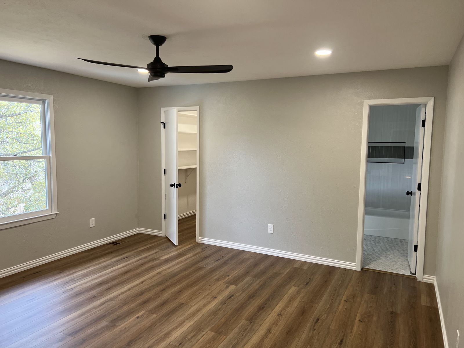 Bedroom with fresh paint, new trim and luxury vinyl plank flooring