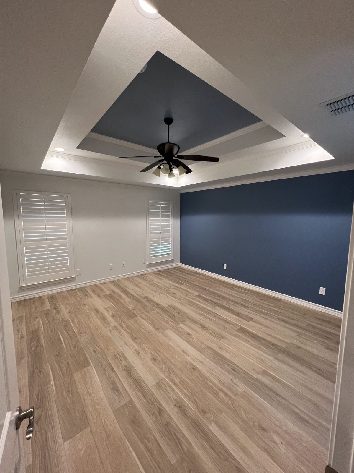 Tray ceiling with navy accent paint and new flooring