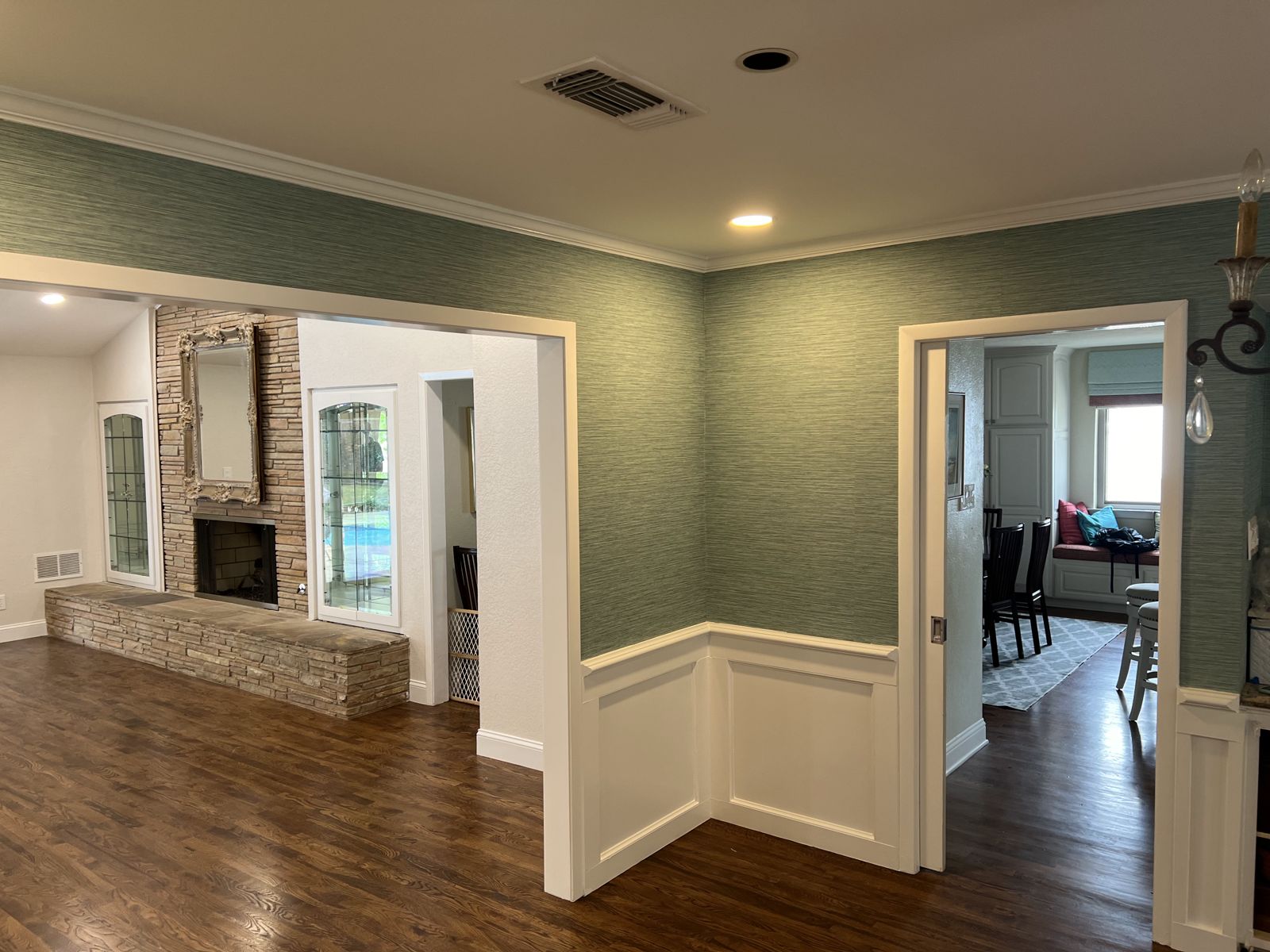 Dining room with painted wainscoting and textured wallcovering